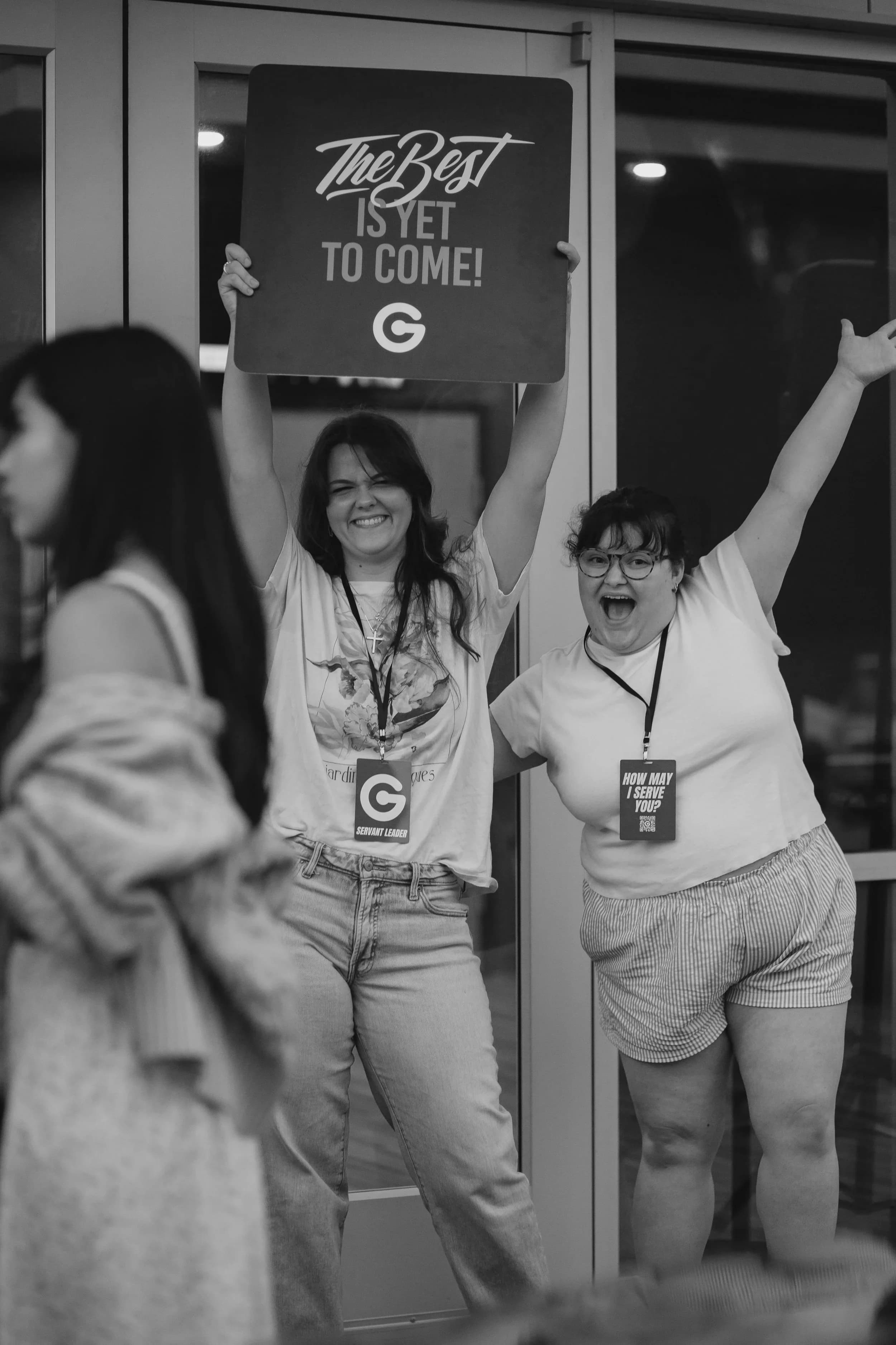Volunteers cheering at the door with welcome signs